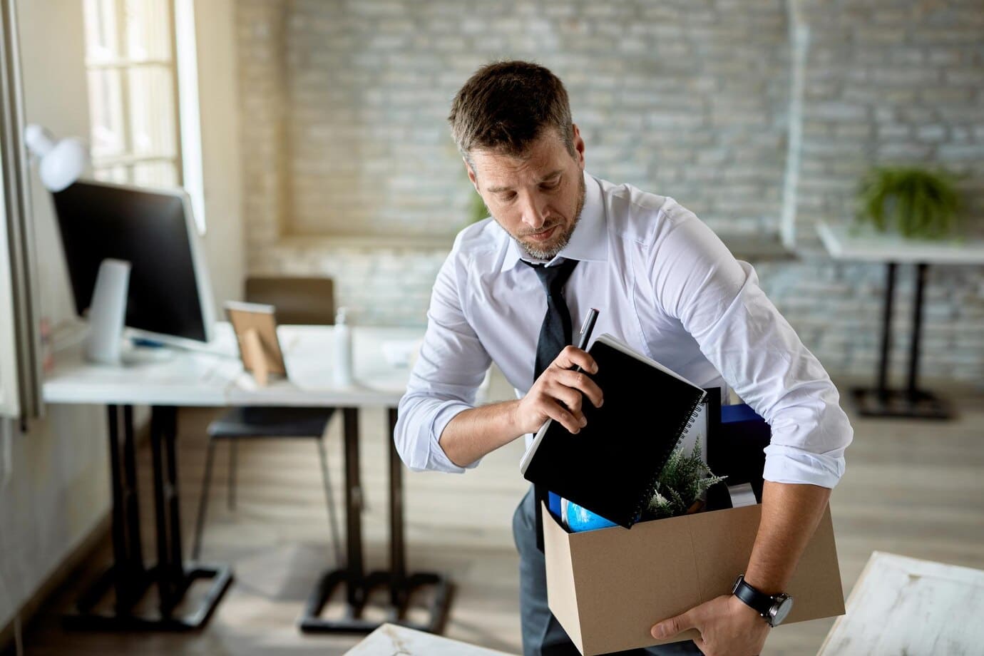 mid-adult-businessman-getting-fired-packing-his-stuff-office_637285-6817